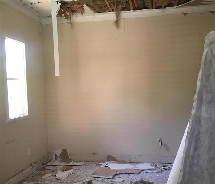Water damage in the master bedroom with sheetrock debris